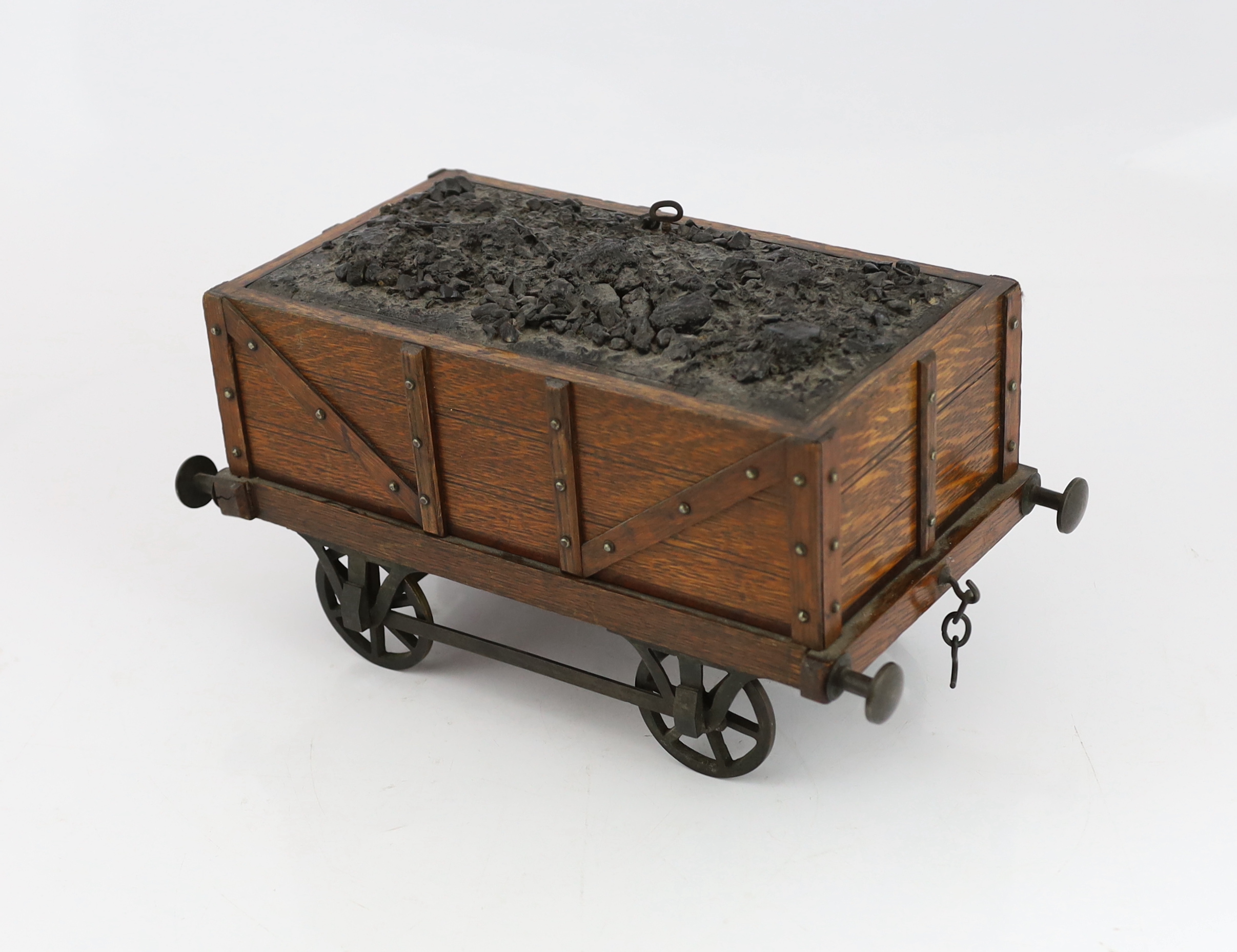 An Edwardian novelty oak smoker's compendium modelled as a railway tender, 34cm wide, 17cm deep, 17cm high